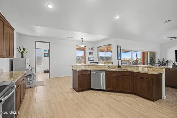 a large kitchen with stainless steel appliances lots of counter space and wooden floor