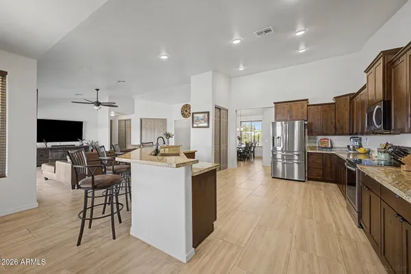 a large kitchen with stainless steel appliances granite countertop a large center island and a sink