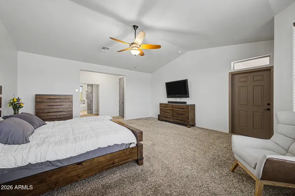 a bedroom with a bed and a chandelier