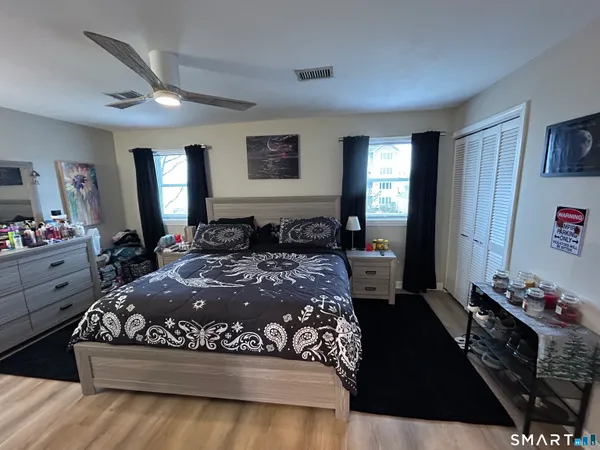a large bed sitting in a bedroom next to a window with dresser