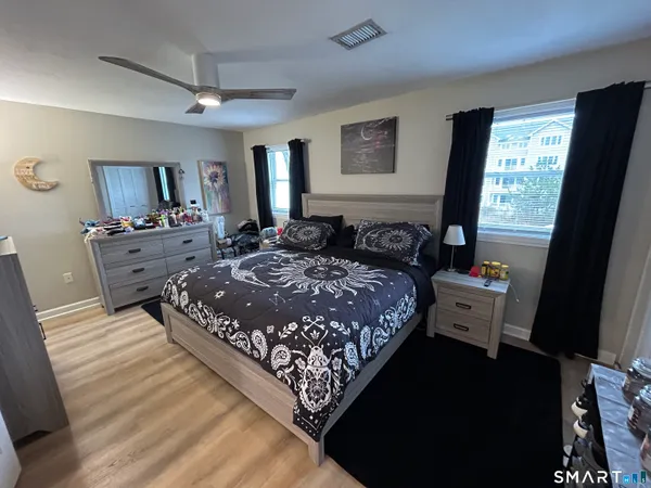 a bed room with a bed window and a dresser