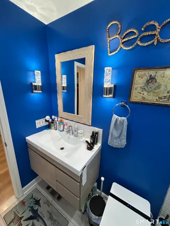 a bathroom with a toilet sink and mirror