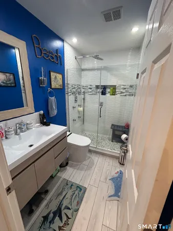 a bathroom with a sink toilet and shower