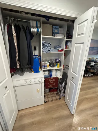 a view of walk in closet with clothes and shoes