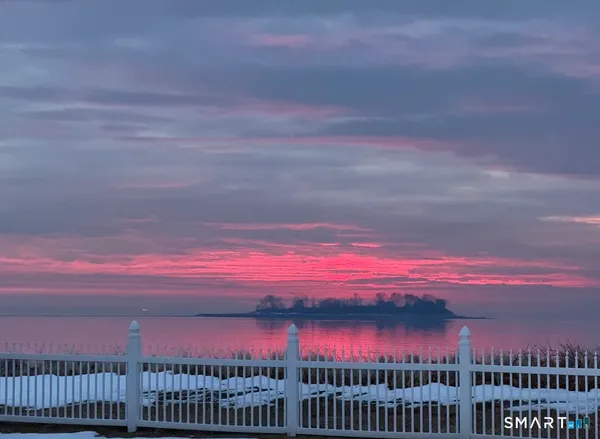 a view of multi story residential apartment building with umbrella in the background