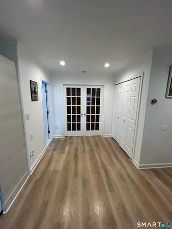 a view of empty room with a window and wooden floor