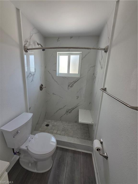 1 Knights Bridge Road, Unit A1 Naples, FL 34112 - Photo 12 of 25 a bathroom with a toilet and a shower