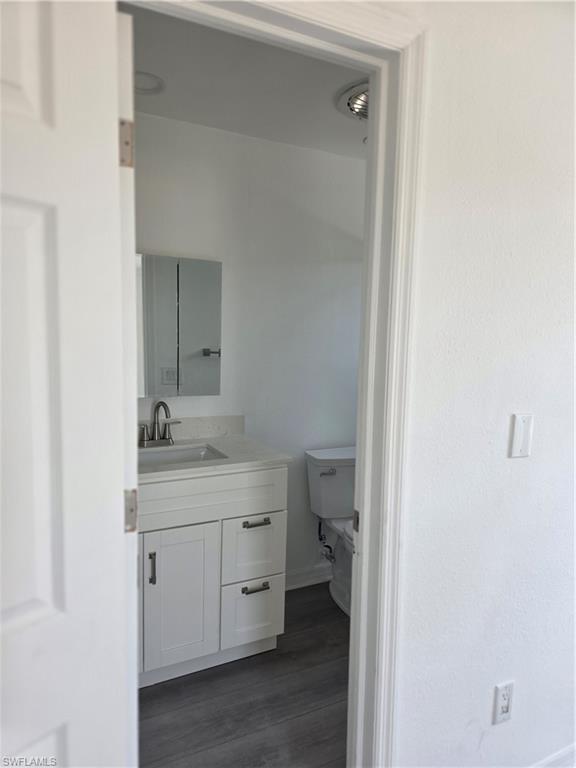 1 Knights Bridge Road, Unit A1 Naples, FL 34112 - Photo 13 of 25 a en suite bathroom with a granite countertop sink toilet and a mirror
