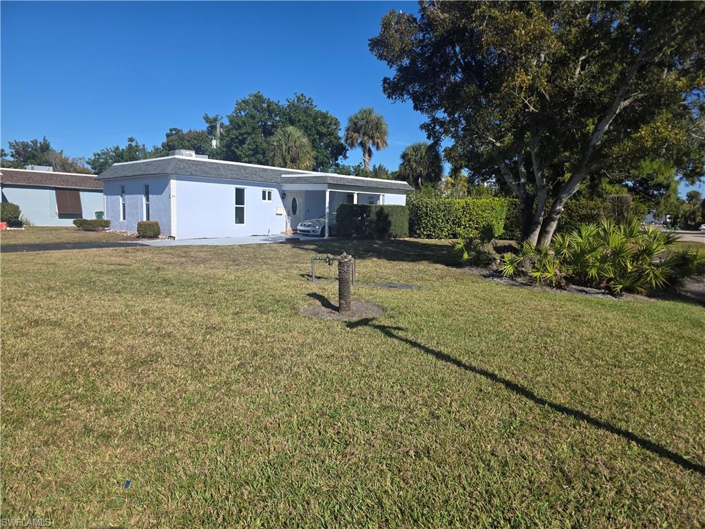 1 Knights Bridge Road, Unit A1 Naples, FL 34112 - Photo 2 of 25 a view of a house with a yard and sitting area
