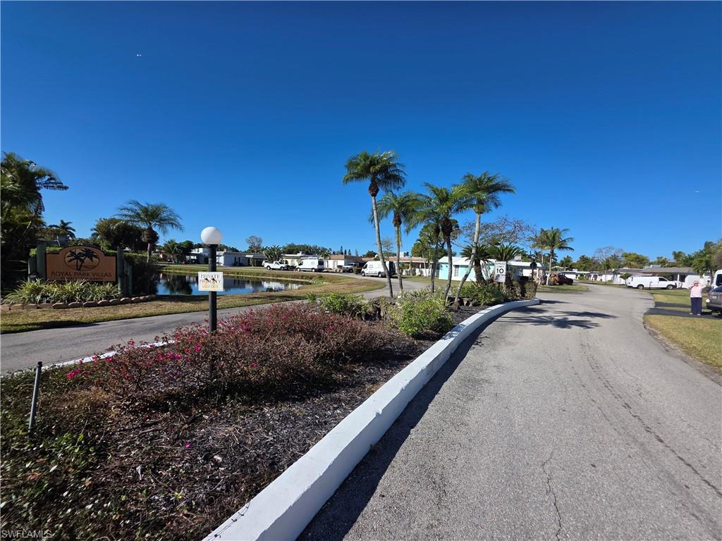 1 Knights Bridge Road, Unit A1 Naples, FL 34112 - Photo 3 of 25 a view of a street with a building and a big yard