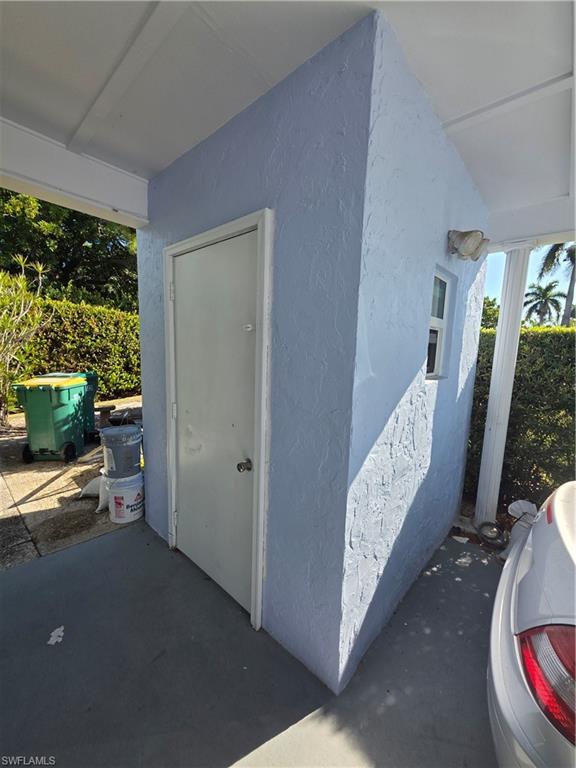 1 Knights Bridge Road, Unit A1 Naples, FL 34112 - Photo 4 of 25 a view of a room that has a bed and a window in it
