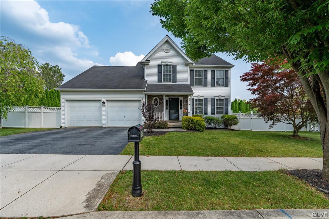 4556 Brighton Road Lower Macungie Township, PA 18062 - Photo 2 of 48 a front view of a house with a yard and garage