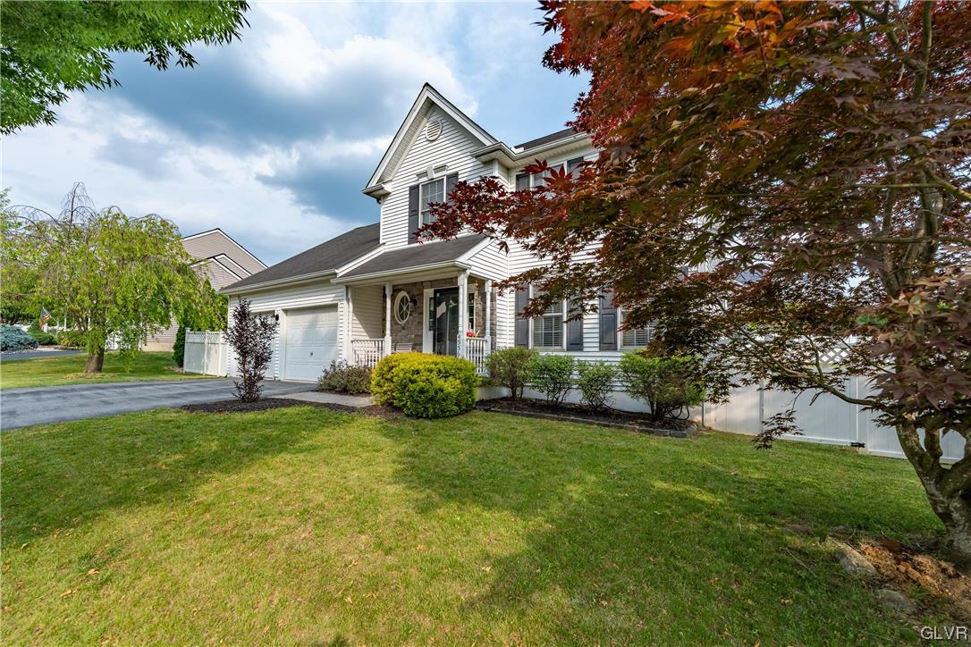 4556 Brighton Road Lower Macungie Township, PA 18062 - Photo 3 of 48 a front view of a house with a yard and trees