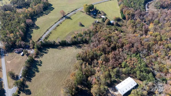 an aerial view of a house with a yard and lake view