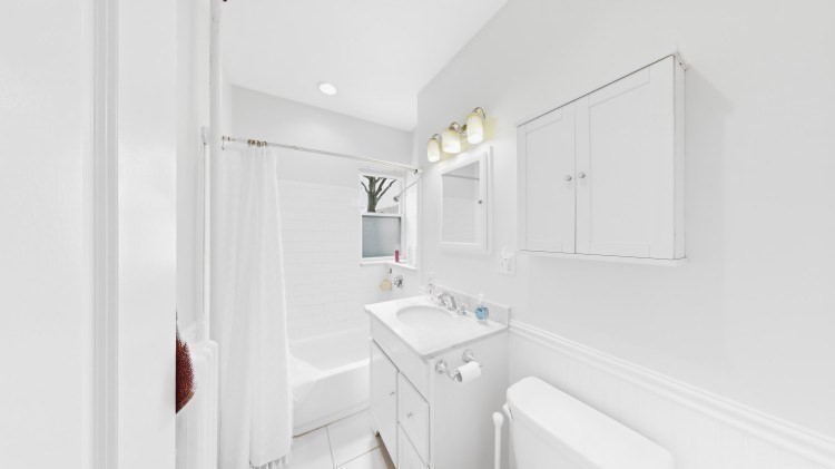 56 Charlesgate East, Unit 138 Boston, MA 02215 - Photo 4 of 17 a bathroom with a sink a toilet and a mirror
