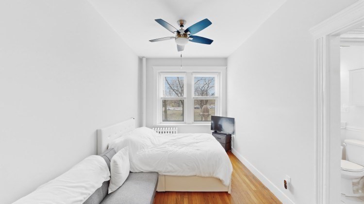 56 Charlesgate East, Unit 138 Boston, MA 02215 - Photo 5 of 17 a bedroom with a bed and a window