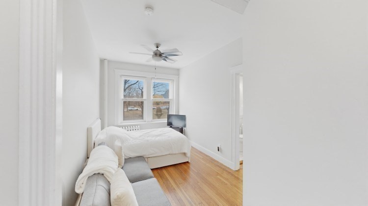 56 Charlesgate East, Unit 138 Boston, MA 02215 - Photo 6 of 17 a bedroom with a bed and a window