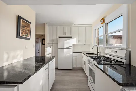 a kitchen with stainless steel appliances granite countertop a stove and a refrigerator