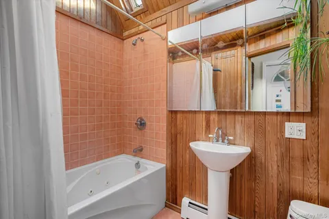 a bathroom with a sink shower and bathtub