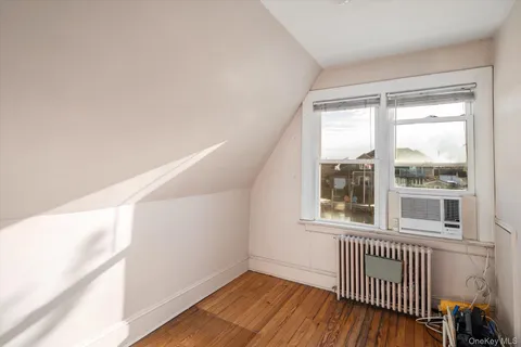 a view of a room with wooden floor and windows