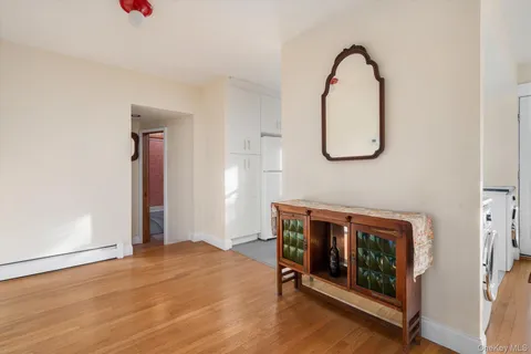a view of a livingroom with wooden floor and entryway