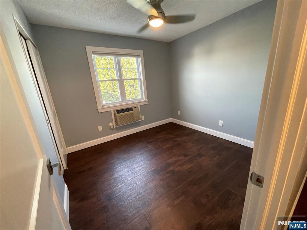 52 Reilly Court, Unit 1 Hackensack, NJ 07601 - Photo 17 of 25 an empty room with wooden floor and windows