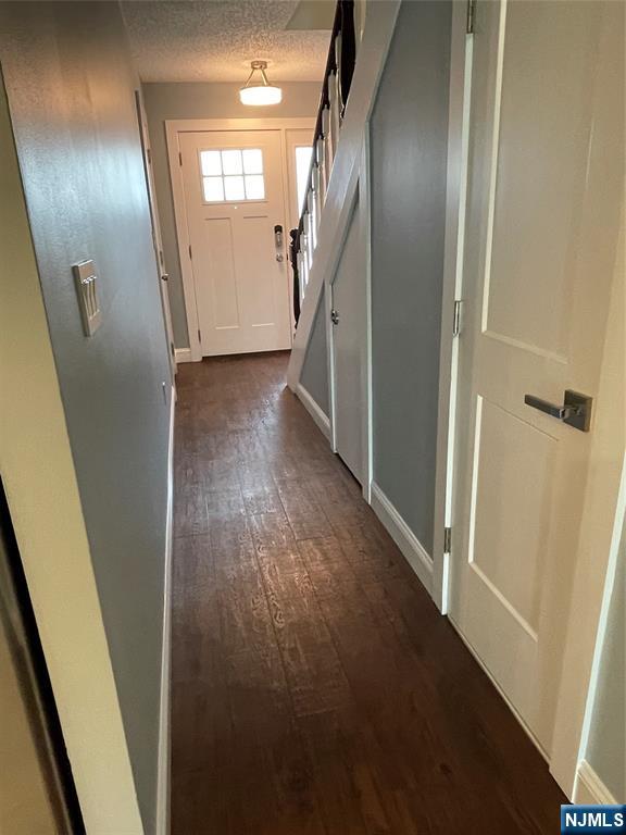 52 Reilly Court, Unit 1 Hackensack, NJ 07601 - Photo 2 of 25 a view of a hallway with wooden floor and stairs