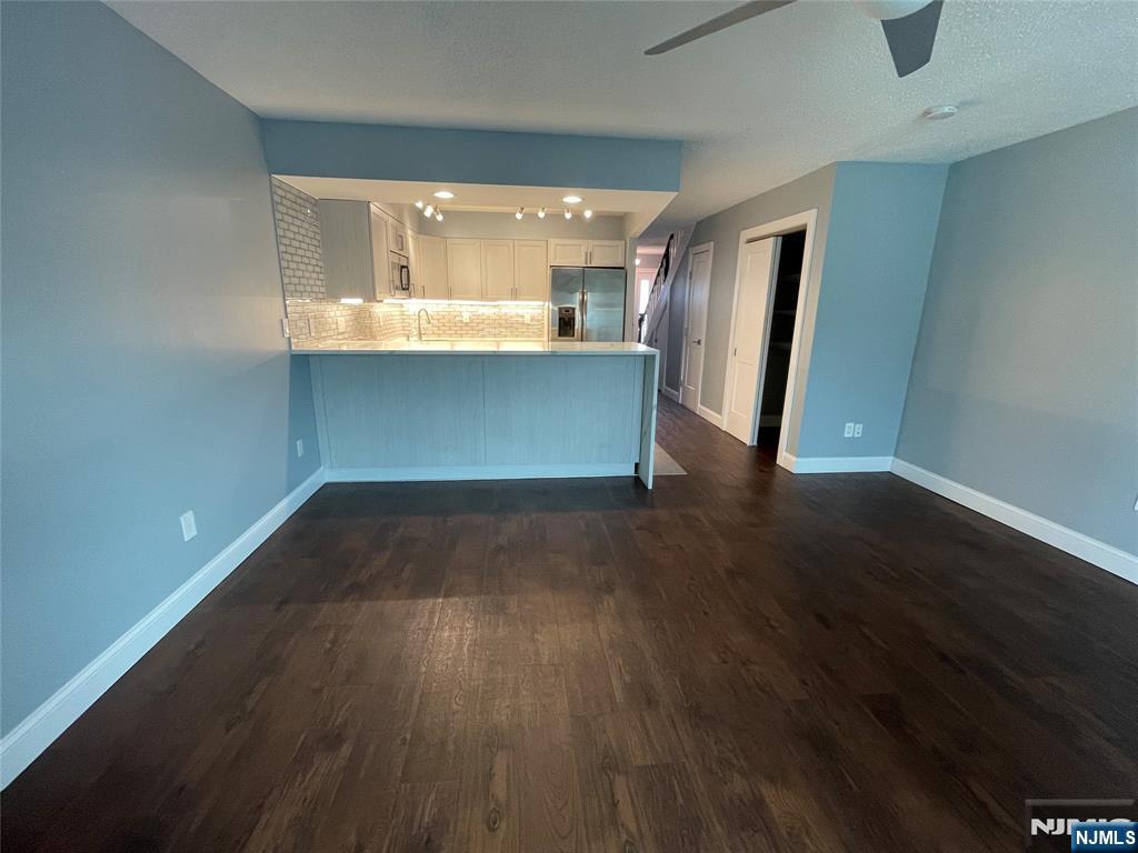 52 Reilly Court, Unit 1 Hackensack, NJ 07601 - Photo 7 of 25 an empty room with wooden floor and windows