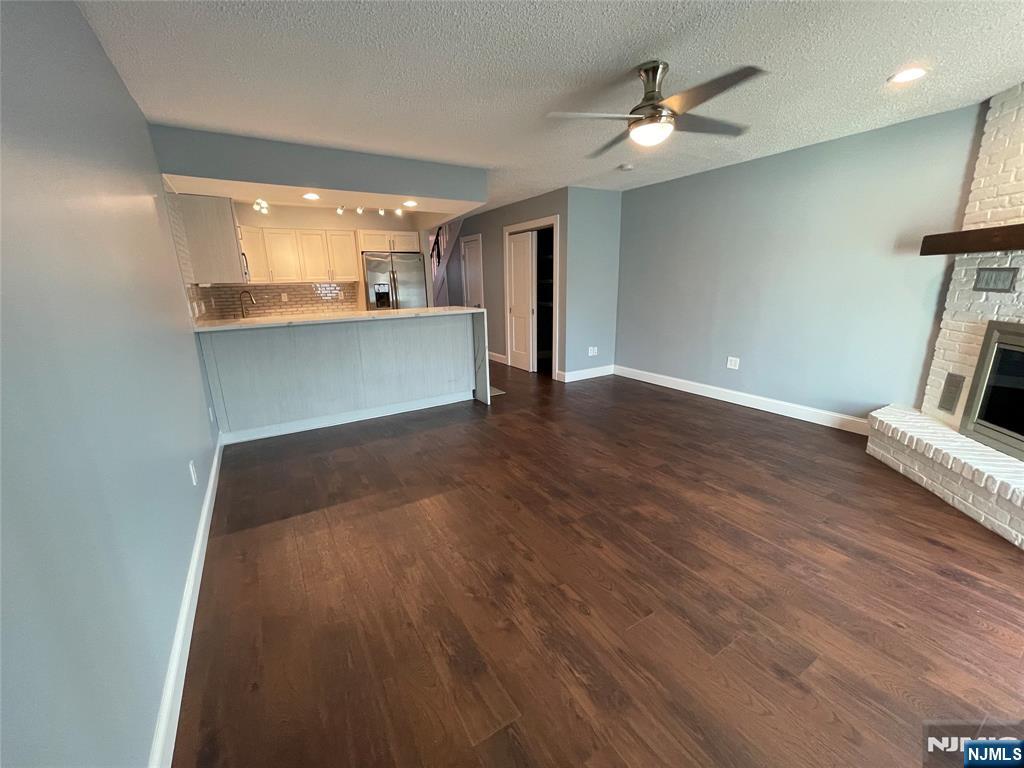 52 Reilly Court, Unit 1 Hackensack, NJ 07601 - Photo 9 of 25 a view of a livingroom with a furniture wooden floor and a ceiling fan