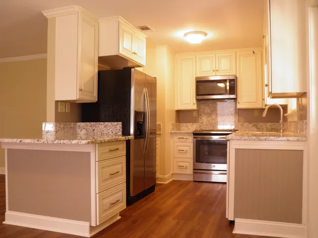 a kitchen with stainless steel appliances a refrigerator stove and sink