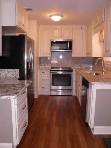a view of room with window and wooden floor