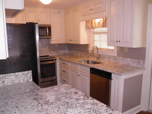 a kitchen with a stove a sink and a refrigerator