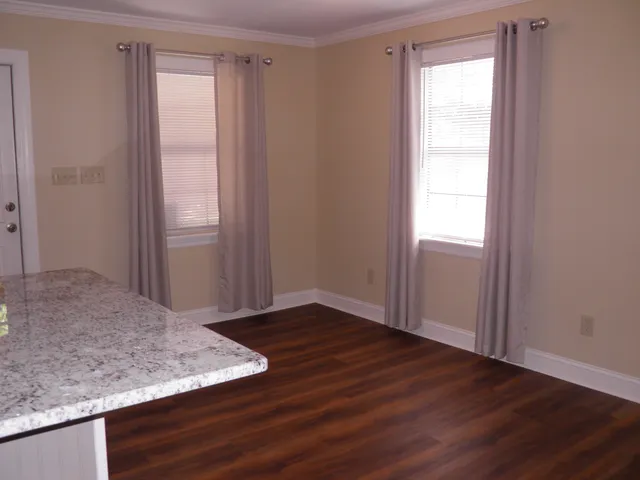 a view of a kitchen with granite countertop cabinets