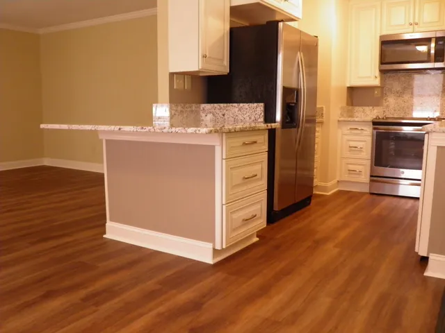 a kitchen with stainless steel appliances a refrigerator and a stove top oven