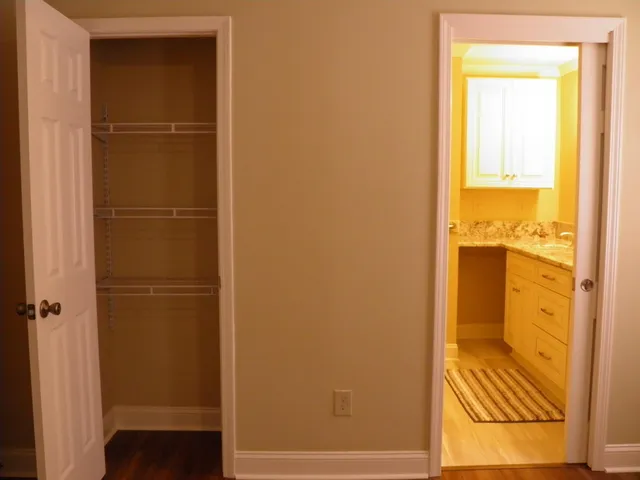 a view of a room with wooden floor and white walls