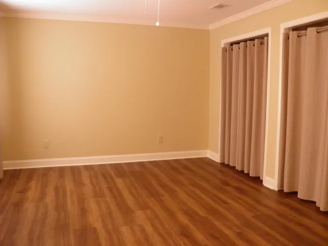 a view of a room with wooden floor