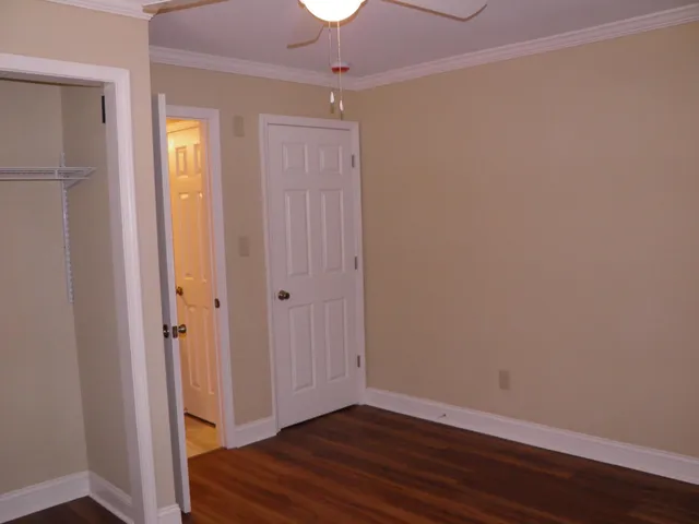 an empty room with wooden floor and closet