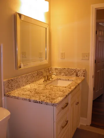 a view of a room with wooden floor