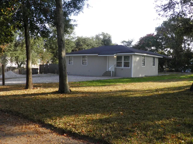 a view of a house with backyard porch and sitting area