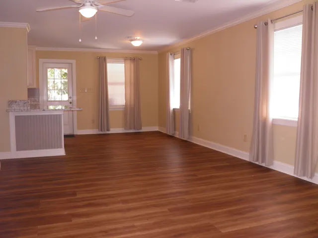 a view of a kitchen with wooden floor and a kitchen