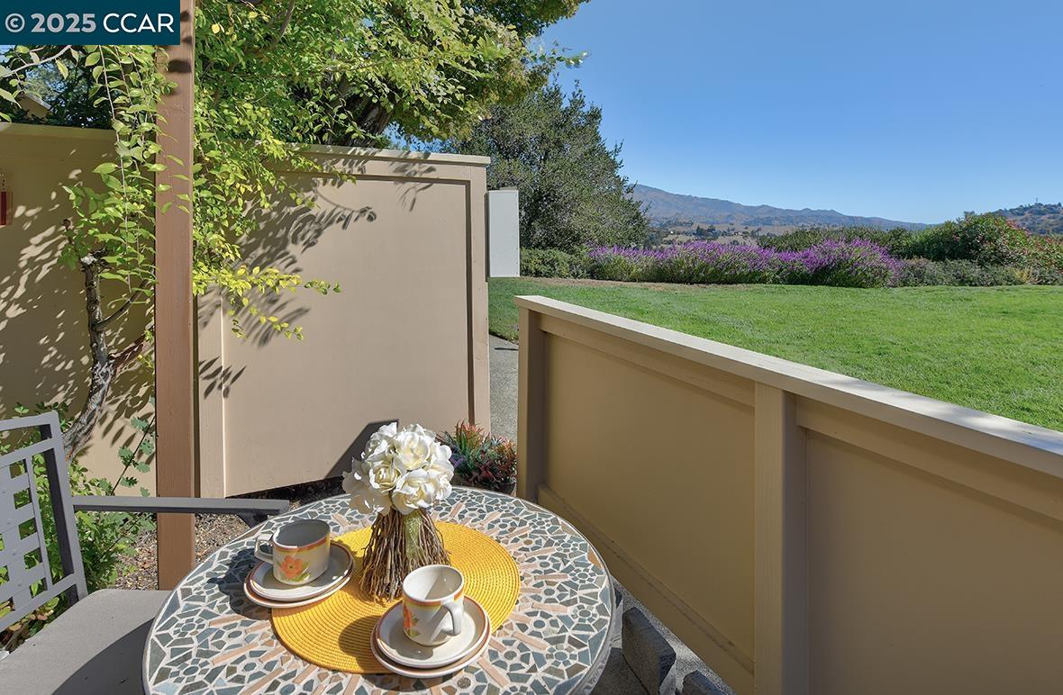2148 Golden Rain Road, Unit 1 Walnut Creek, CA 94595 - Photo 12 of 48 a view of a balcony with a table and chairs