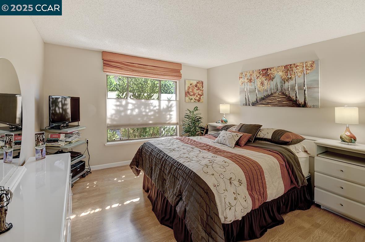 2148 Golden Rain Road, Unit 1 Walnut Creek, CA 94595 - Photo 24 of 48 a bedroom with a bed and a flat screen tv