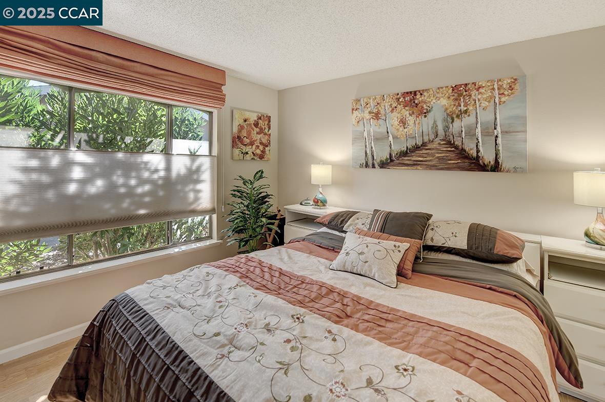 2148 Golden Rain Road, Unit 1 Walnut Creek, CA 94595 - Photo 25 of 48 a bedroom with a large bed and a large window