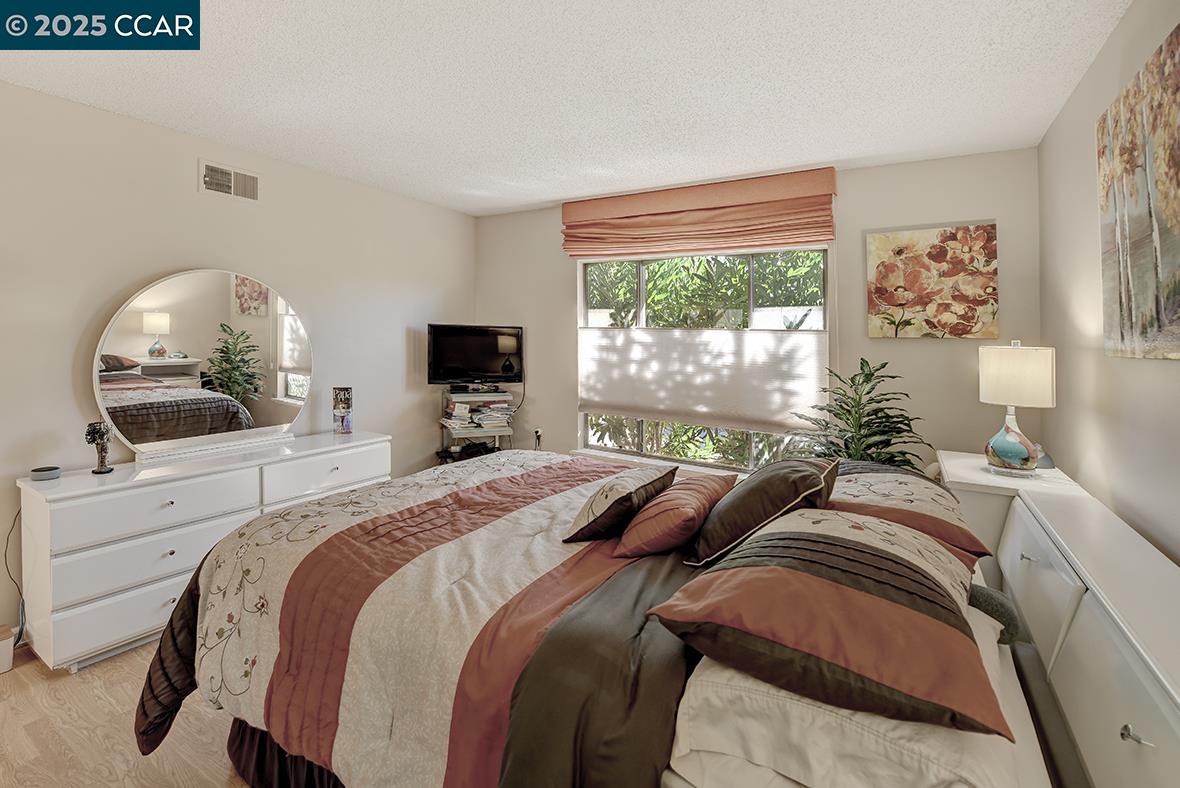 2148 Golden Rain Road, Unit 1 Walnut Creek, CA 94595 - Photo 27 of 48 a bedroom with a large bed and a tv