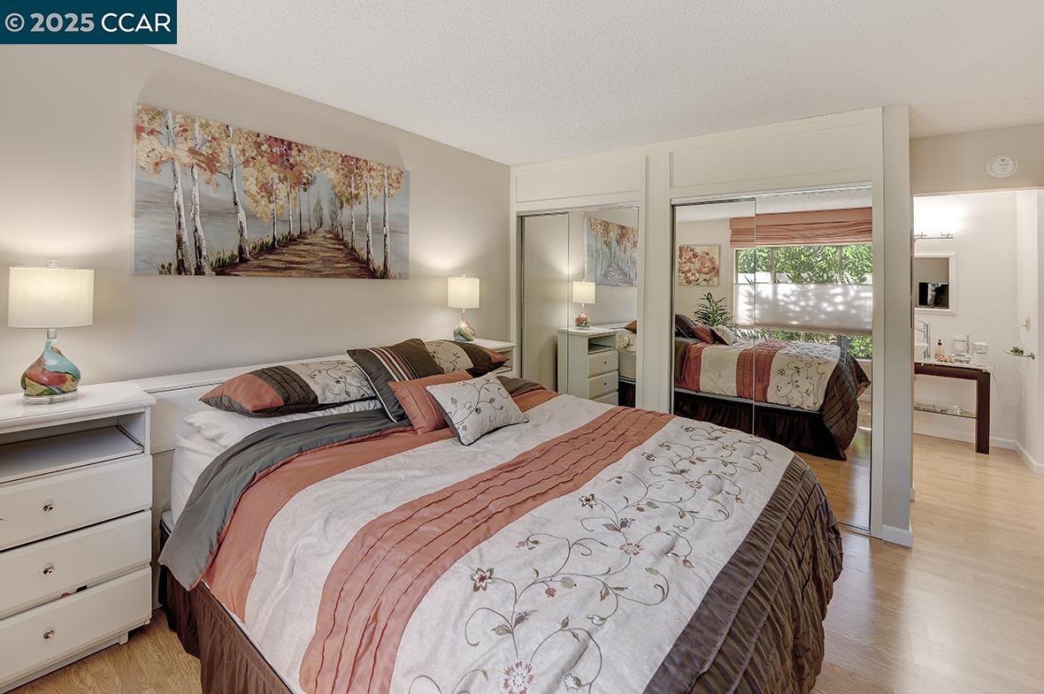2148 Golden Rain Road, Unit 1 Walnut Creek, CA 94595 - Photo 28 of 48 a bedroom with a large bed and a chandelier