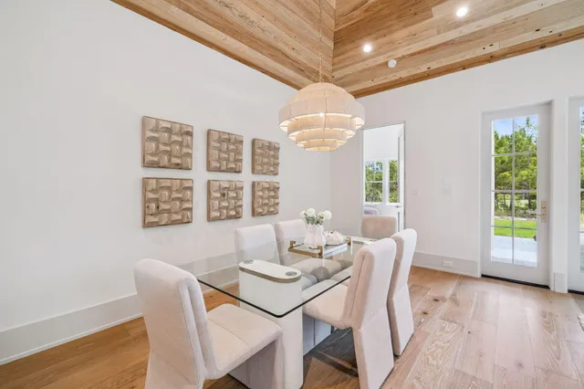 a view of a dining room with furniture wooden floor and chandelier