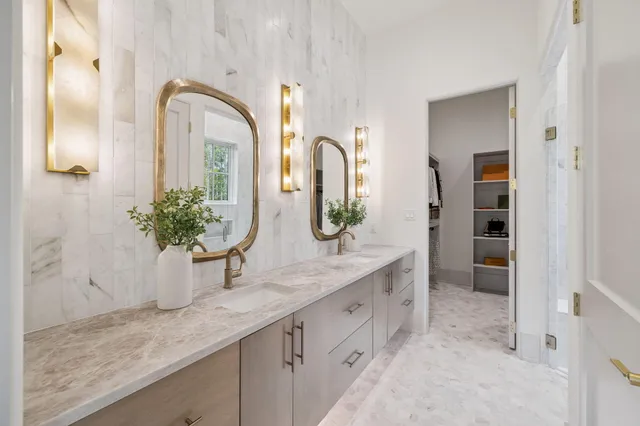 a bathroom with a double vanity sink and a mirror