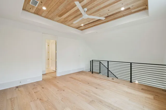 a view of a room with wooden floor