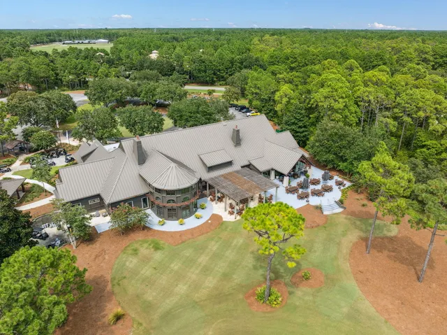 an aerial view of a house with yard swimming pool and outdoor seating