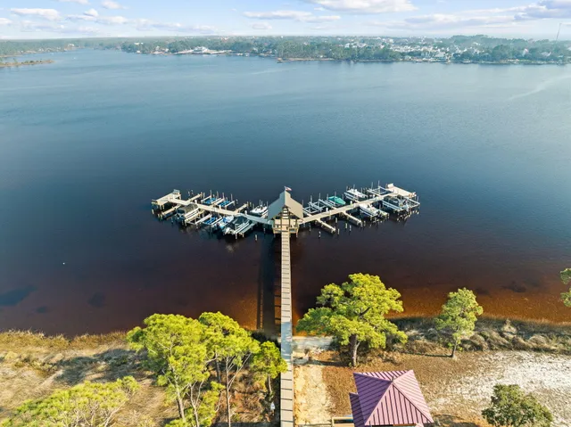 a vase of flowers sitting on a wooden floor